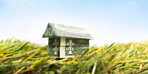 picture of a house crafted out of a dollar bill